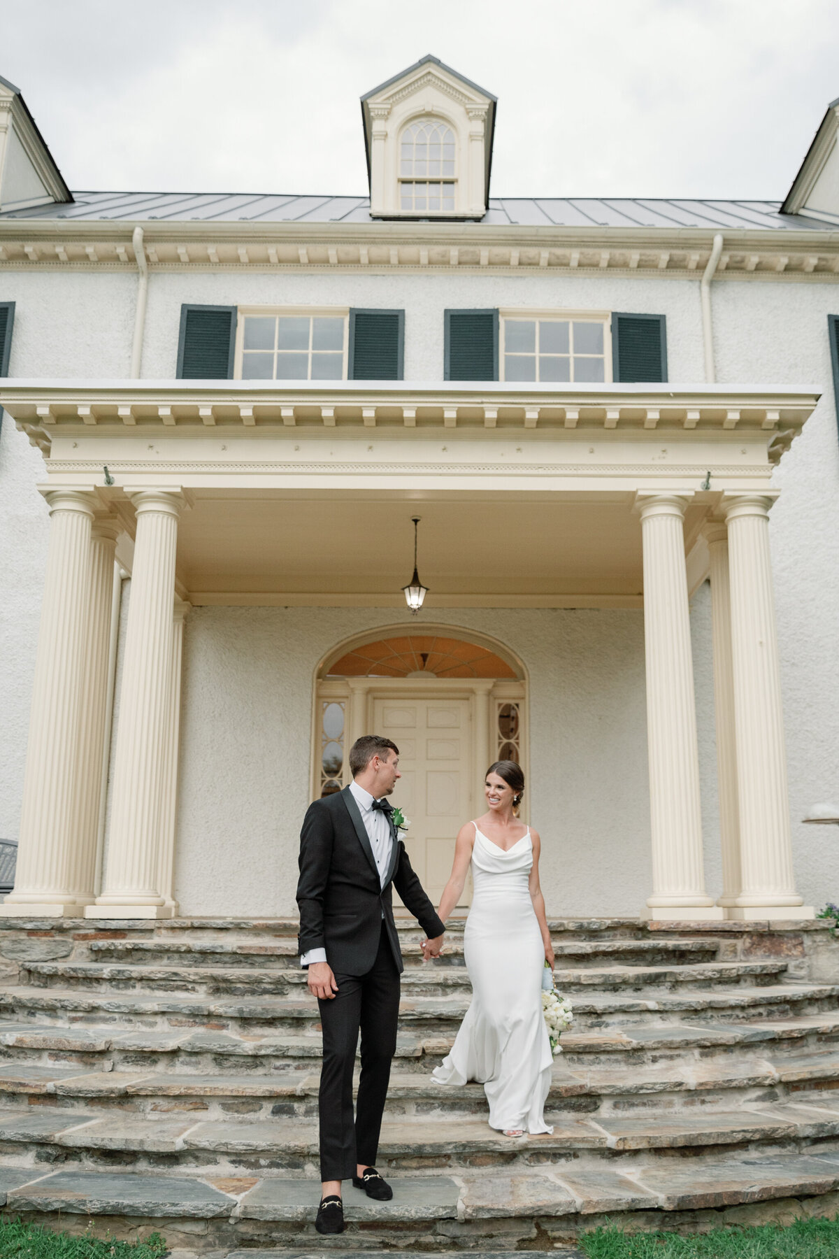 Bride and groom walking down the steps at Rust Manor House