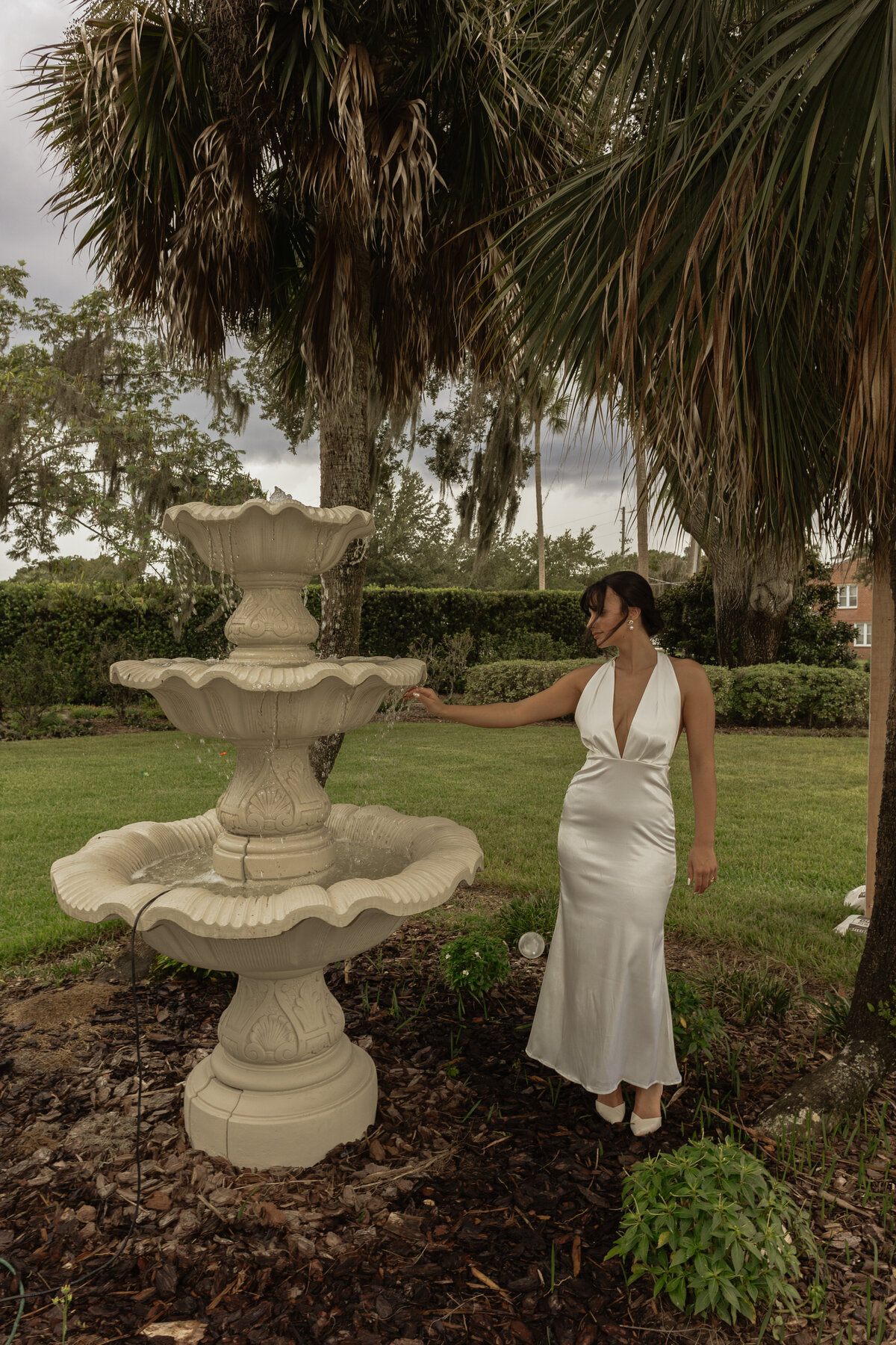 Luxury Florida wedding surrounded by tall palm trees and tropical details at The Palm Mansion in Umatilla