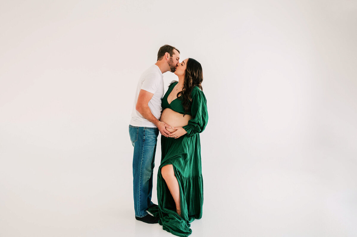 pregnant couple kissing in maternity photography studio in Springfield MO
