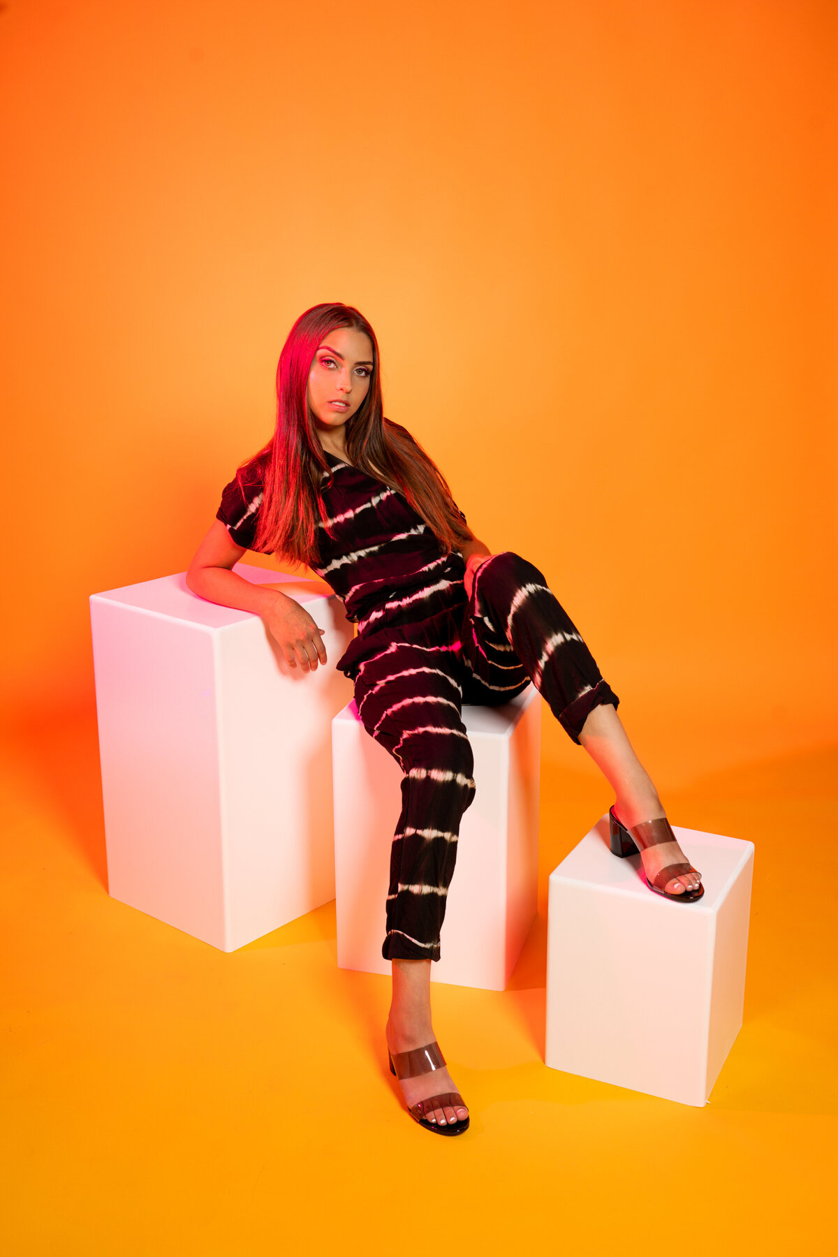 Lino Lakes Minnesota high school senior  photo of girl in jumpsuit on colorful studio background