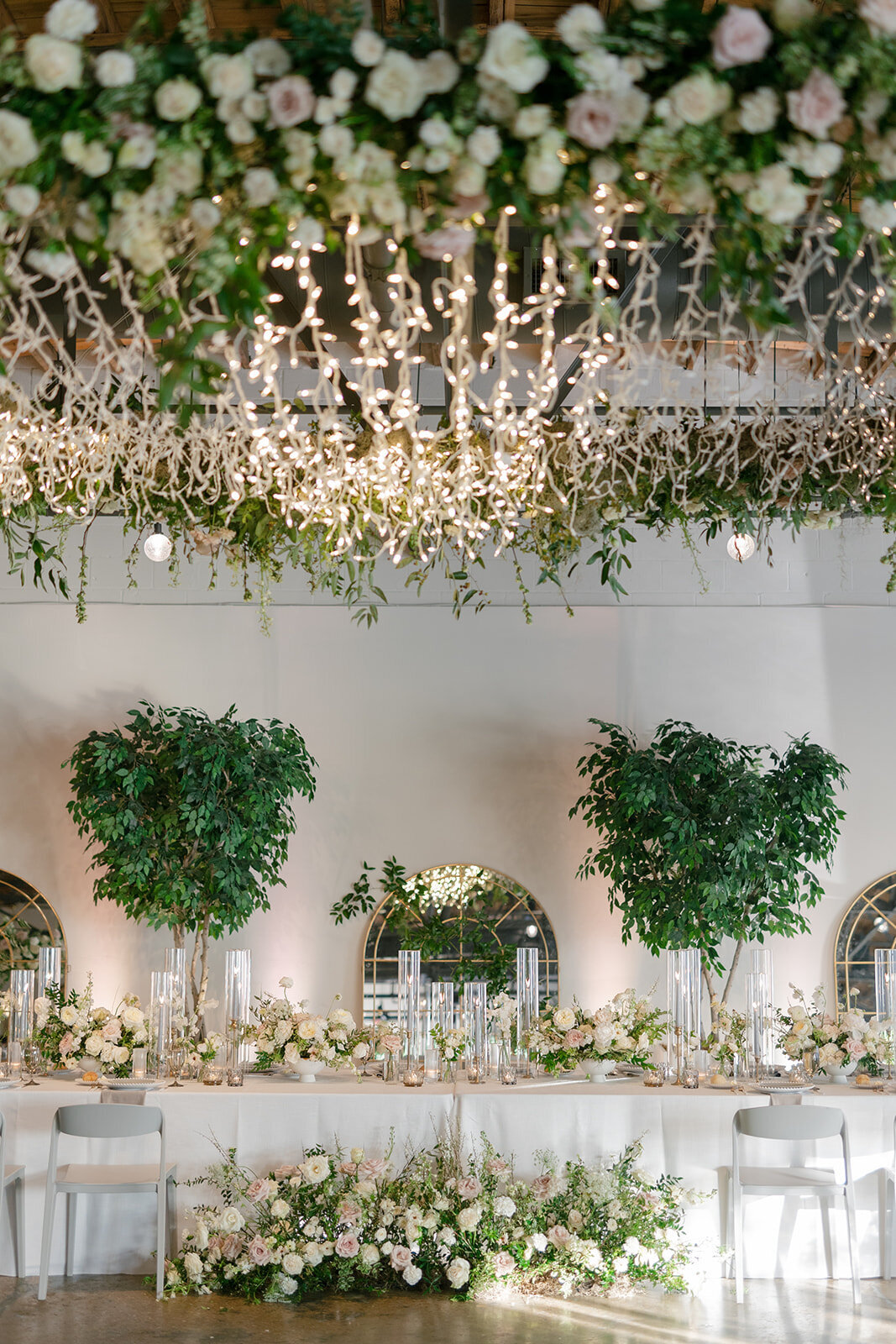 Classic white, cream, and blush wedding flowers. Florals composed of roses, ranunculus, Queen Anne’s lace, and greenery. Designed by Rosemary and Finch in Nashville, TN.