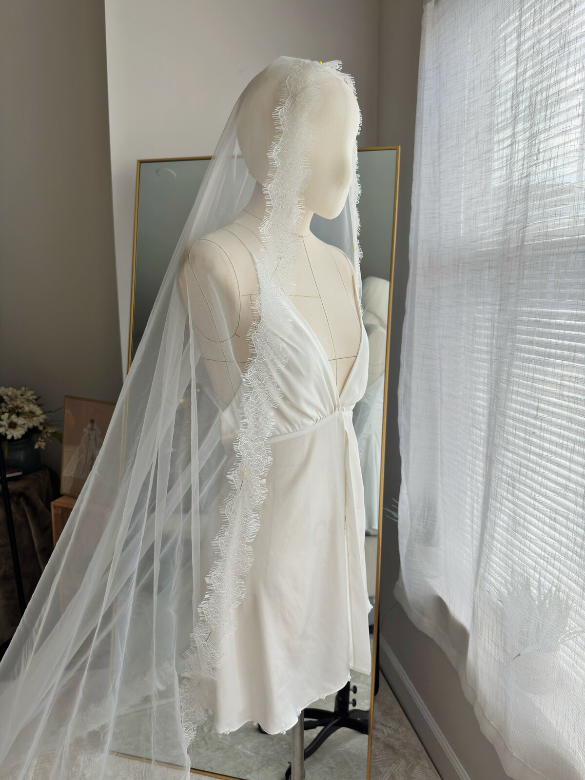 Romantic cathedral-length mantilla veil draped over soft curls
