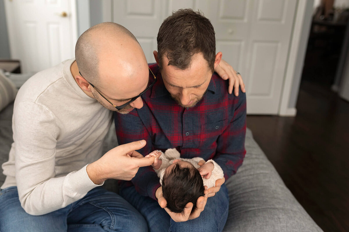 NJ Newborn photos of two dads holding their baby's hands
