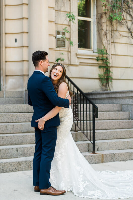 Candid capture of a groom whispering into the bride's ears