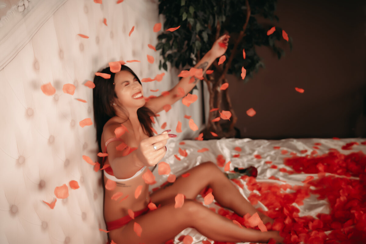 A woman in two piece red outfit throwing rose petals in  Minnesota