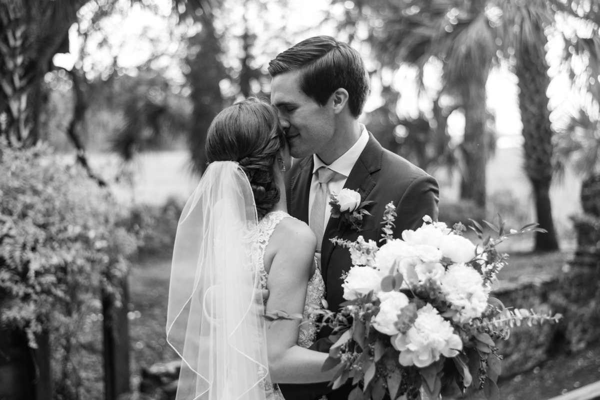 groom holding bride during first look at sugar mill ruins callawassie island by  south carolina wedding photographer