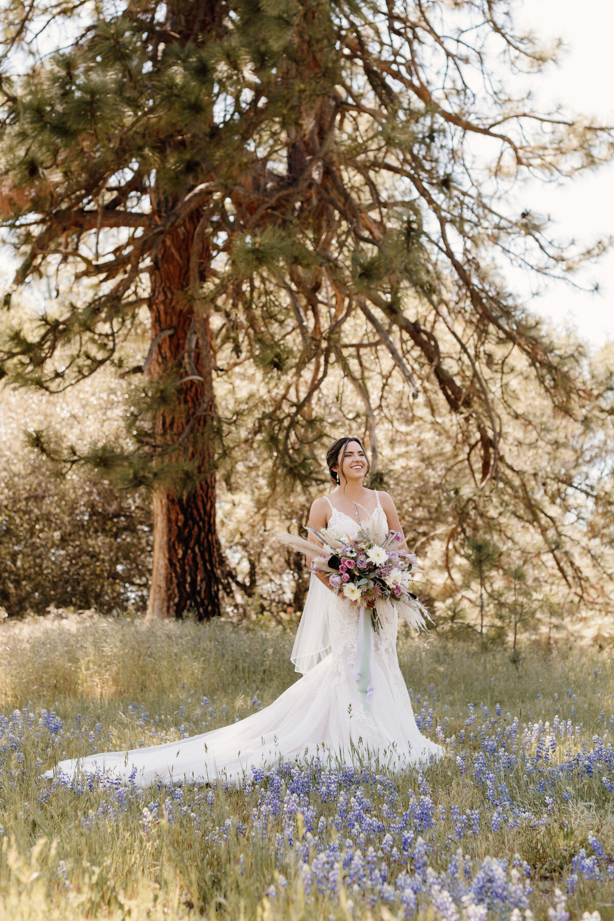 bride stands in flower field