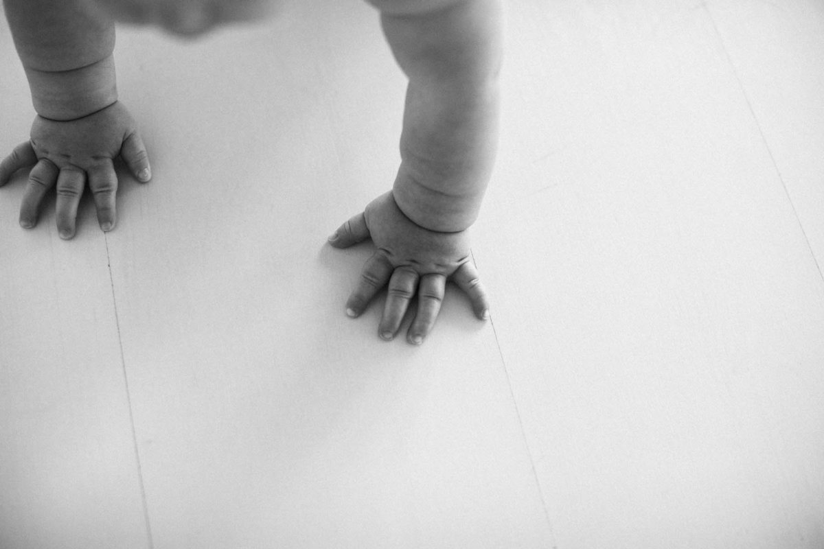 black and white image of baby's hands