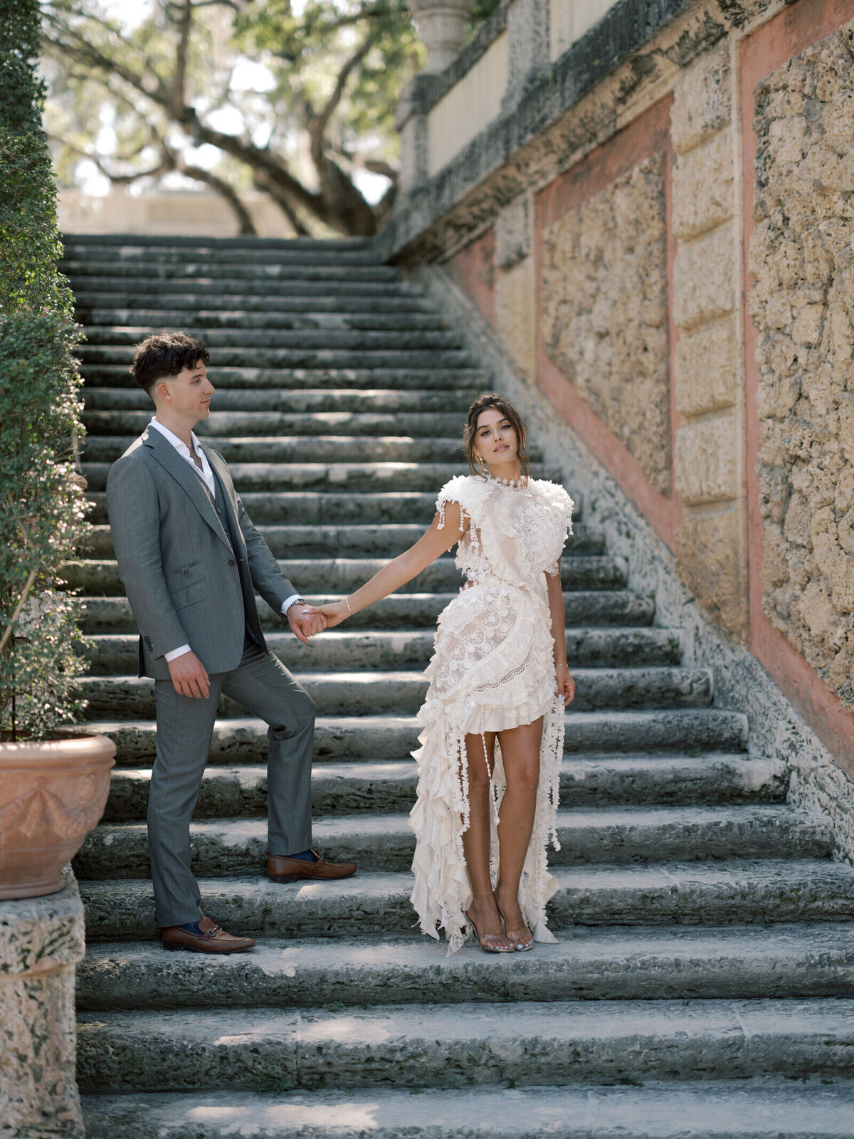 vizcaya-engagement-couple-holding-hands-steps