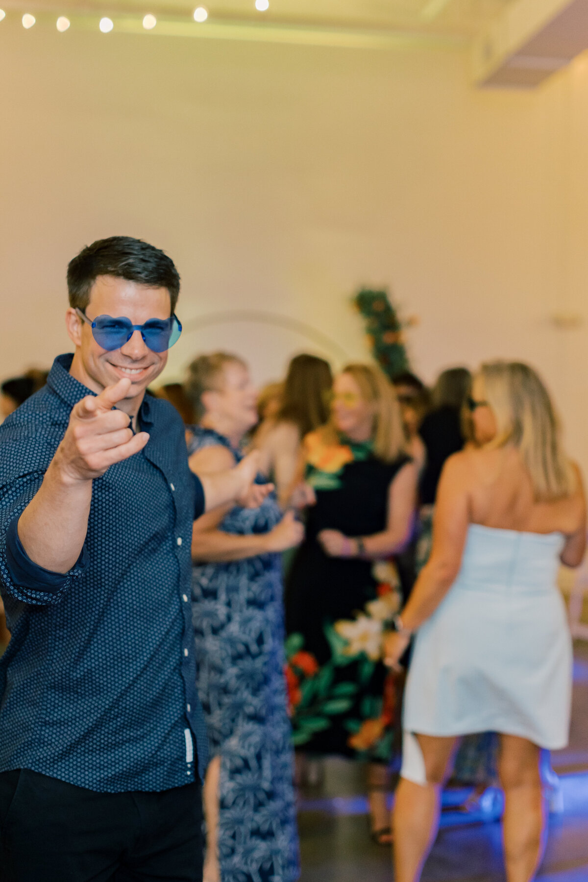 Wedding guests dancing under colorful lighting during Brendan and Sara’s reception at Fetewell in Baltimore.