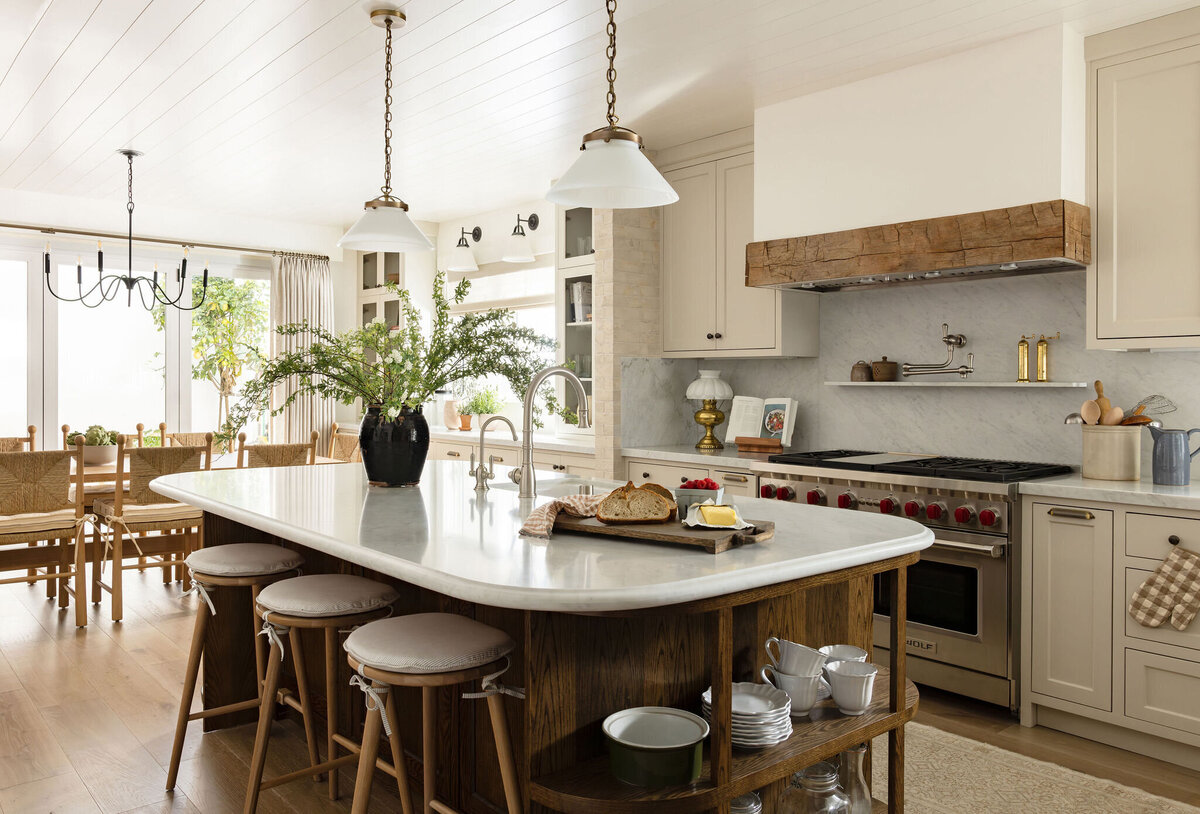 Elegant kitchen with marble countertops and feminine coastal details

