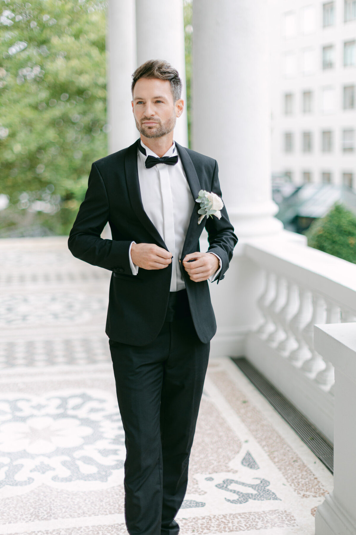 Luxury groom at palace Coburg in Vienna welcoming his weddings guests 