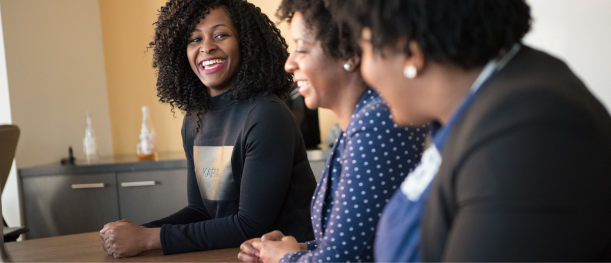 Two women smiling and representing the welcoming and collaborative spirit of The Ferguson Centers for Leadership Excellence's network of partners. They invite you to join their network of passionate individuals who are committed to driving diversity, equity, and inclusion in real estate and related sectors through educational, mentoring, and career opportunities.