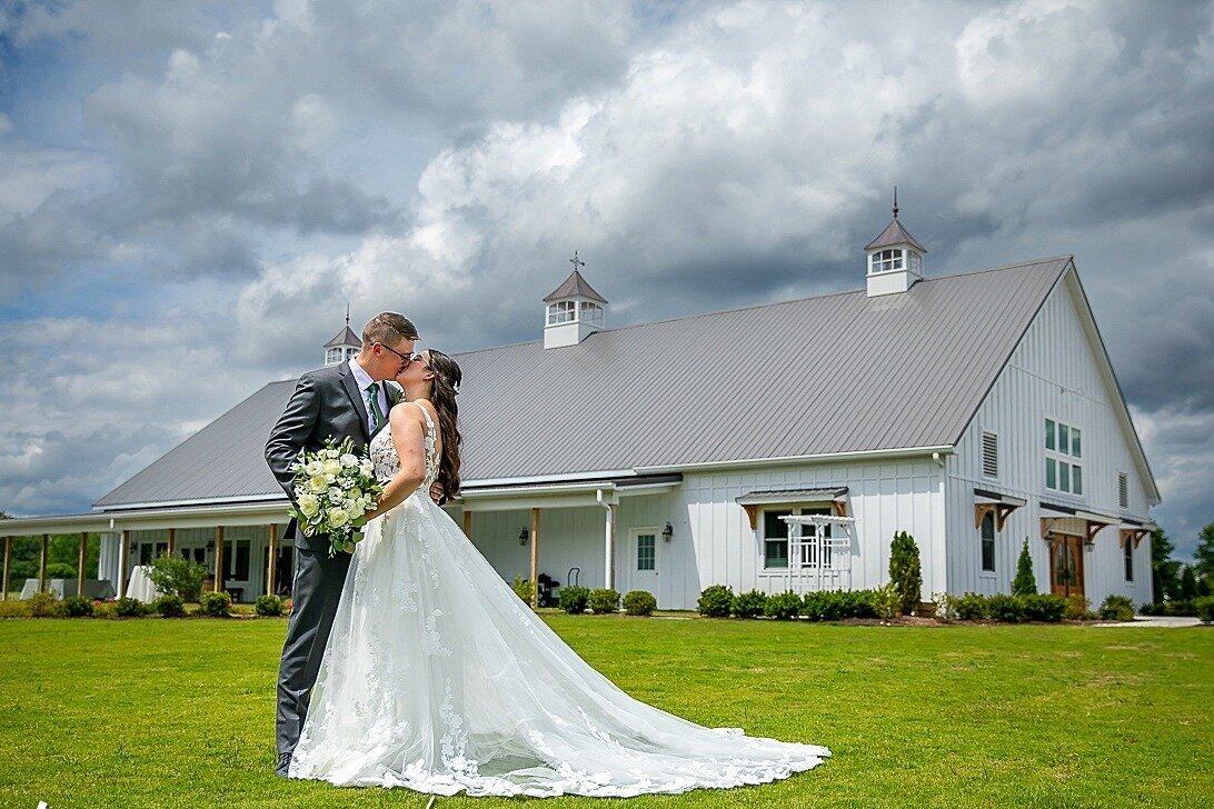 Bride-Groom-Kiss-White-Wedding-Dress-Veranda--Barn-The-Legacy-at-Willow-Pond.JPG