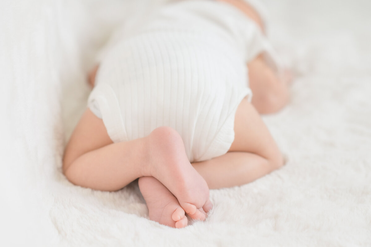 baby feet crossed while sleeping during newborn session in baltimore md