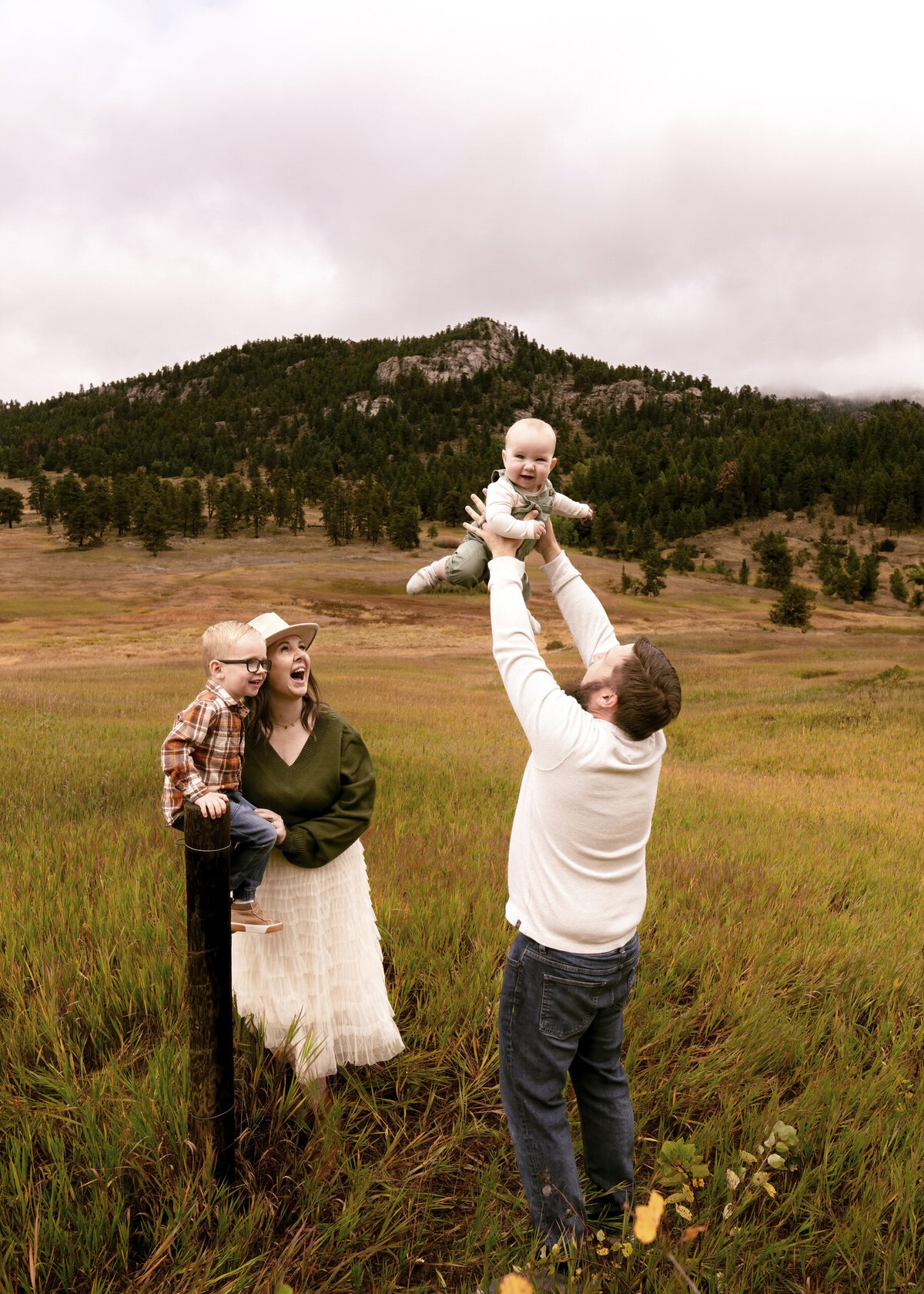 dad playfully tossing baby in air