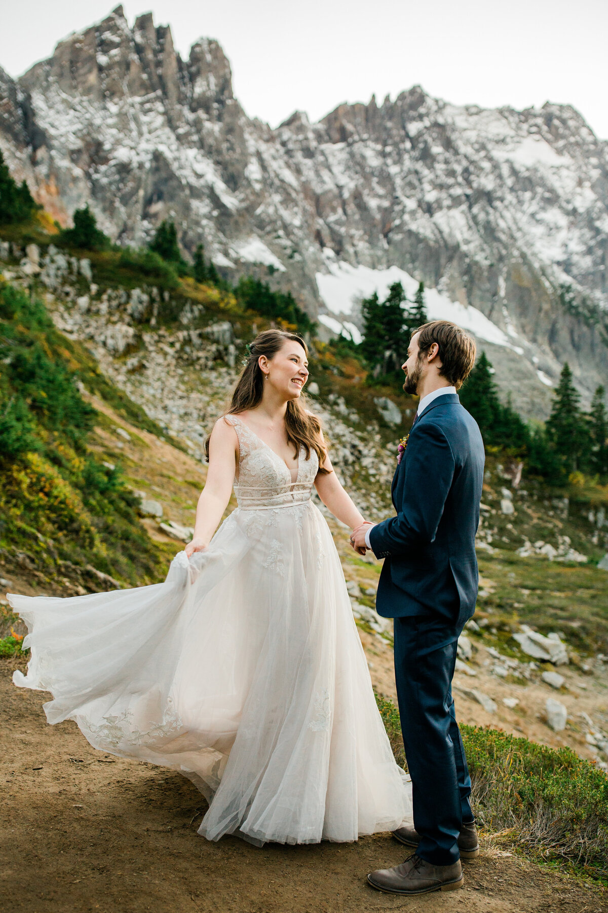 Bride & groom smiling at each other during elopement along Cascades Pass trail in North Cascades National Park!