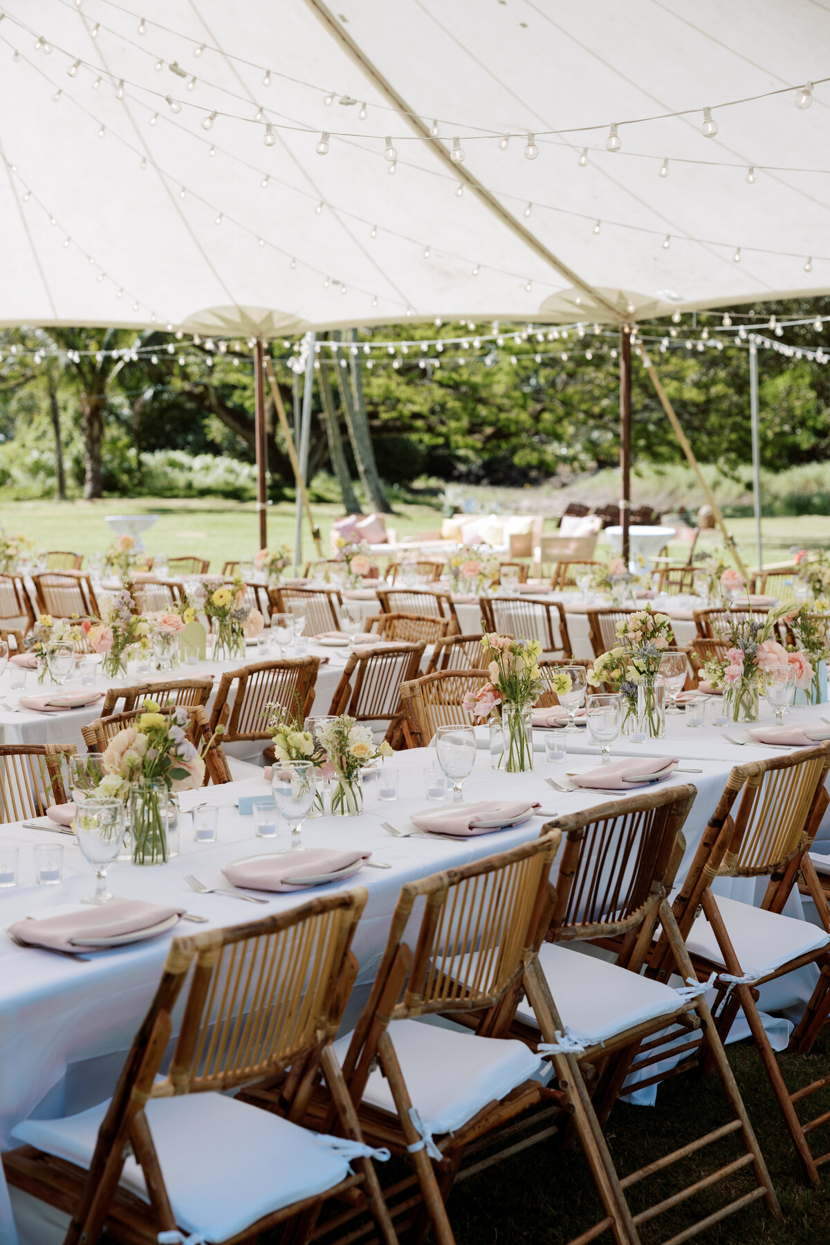 Sunny tropical wedding tablescape captured on film, highlighting vibrant florals and elegant details by Kate Winters Photography.