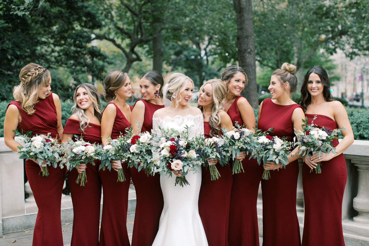 bride laughing with bridesmaids on wedding day