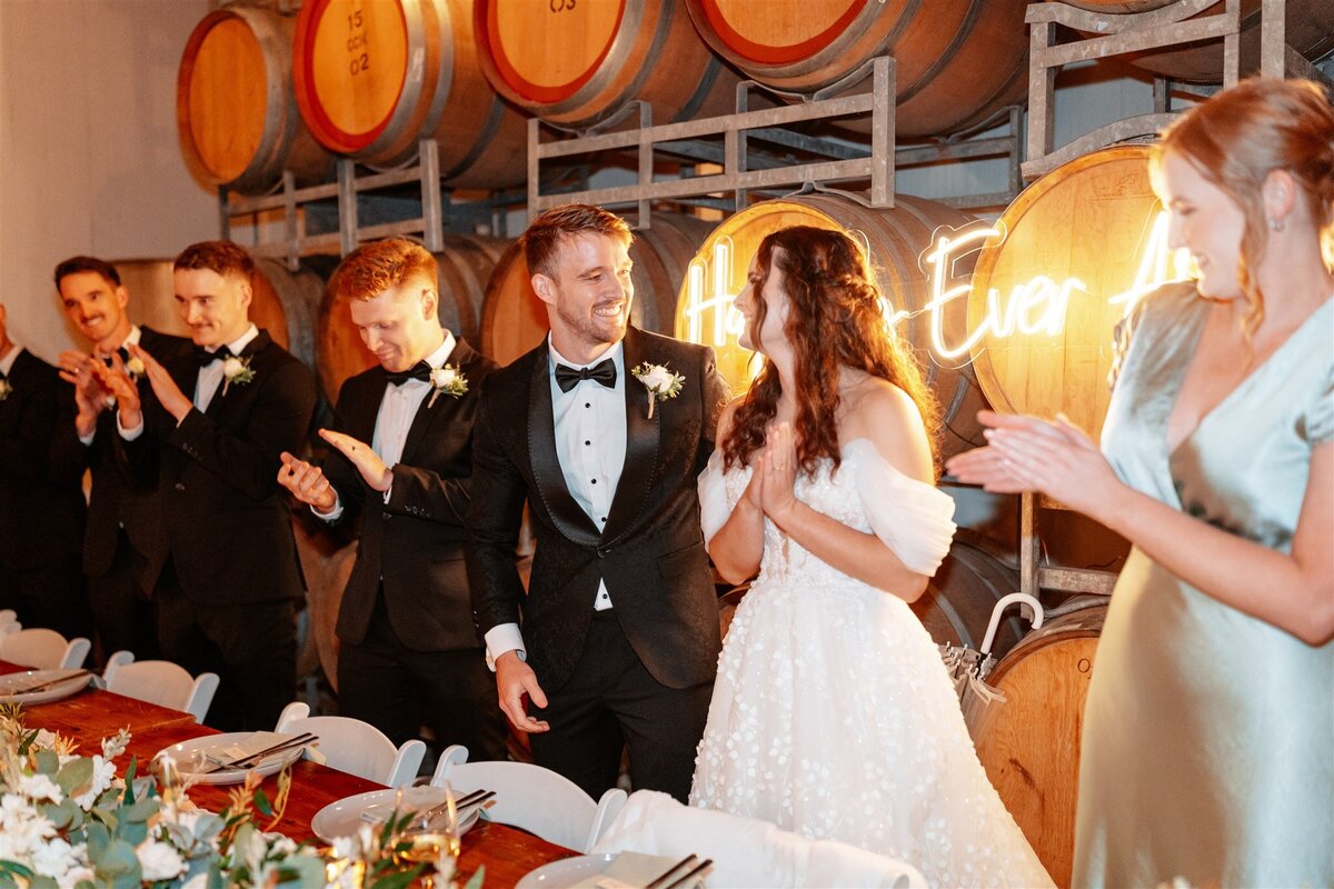 A charming moment captured as the couple shares a joyous dance amidst their wedding reception festivities.