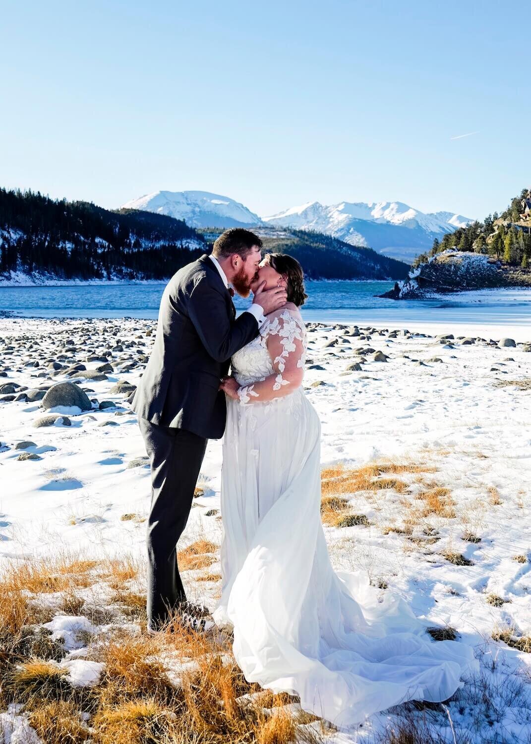 denver wedding photography - couple kissing in front of mountains