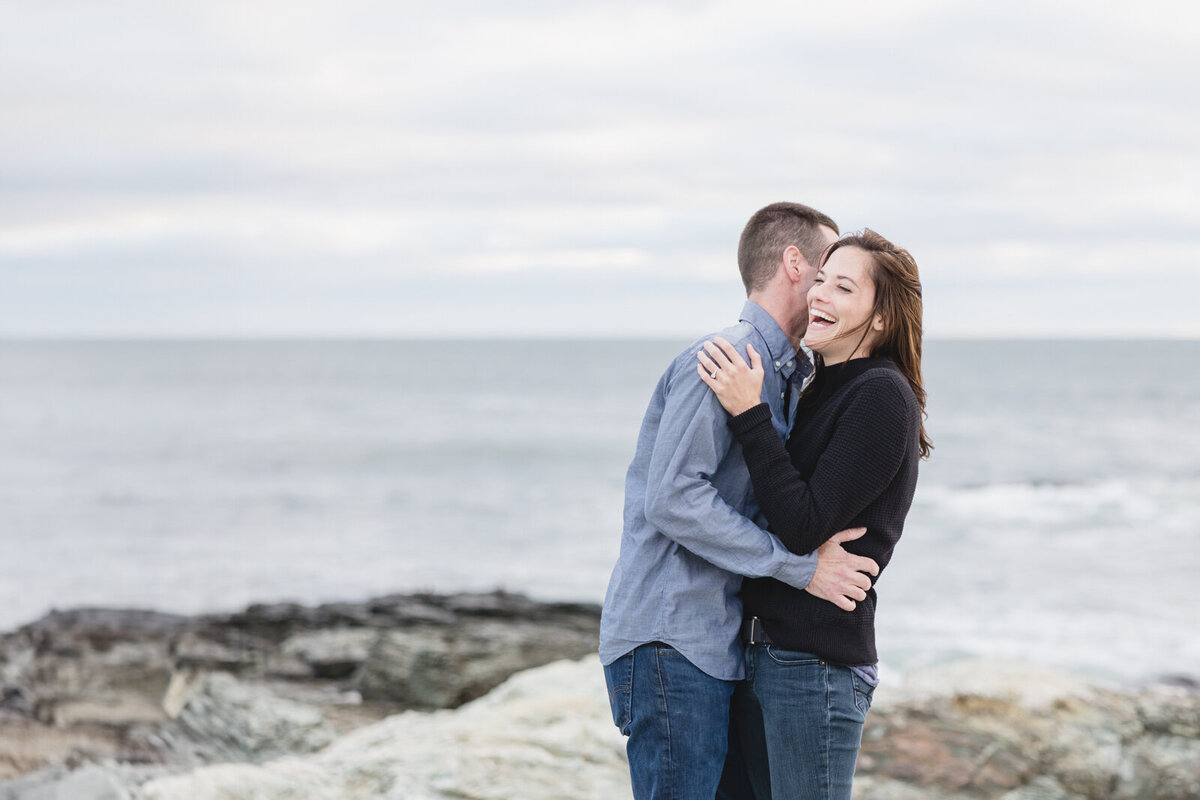 Couple laughing and having fun during their engagement shoot in Newport