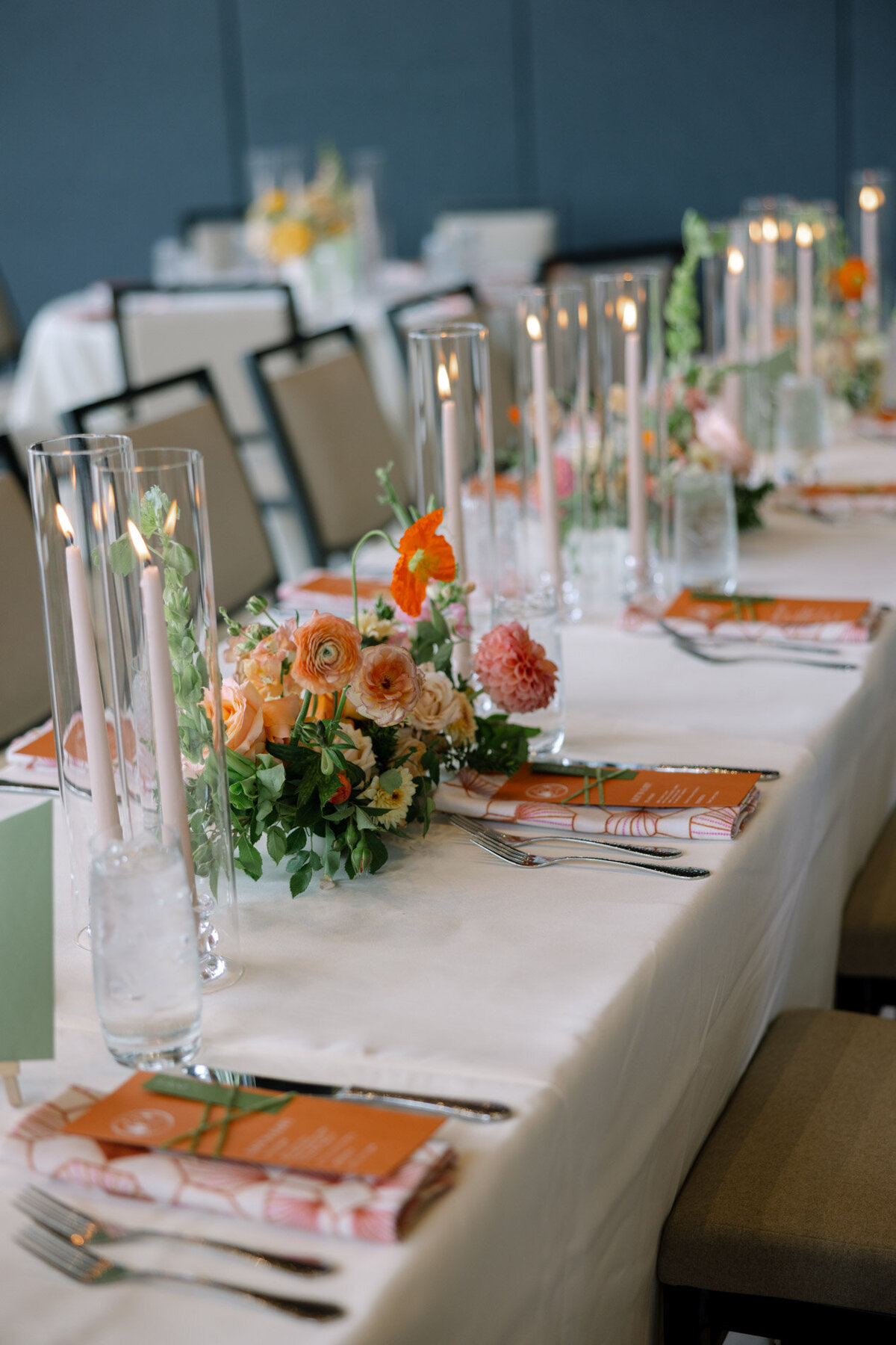 custom calligraphy wedding menu on a printed cloth napkin with florals and flatware representing full service design and calligraphy by Life in Letters.