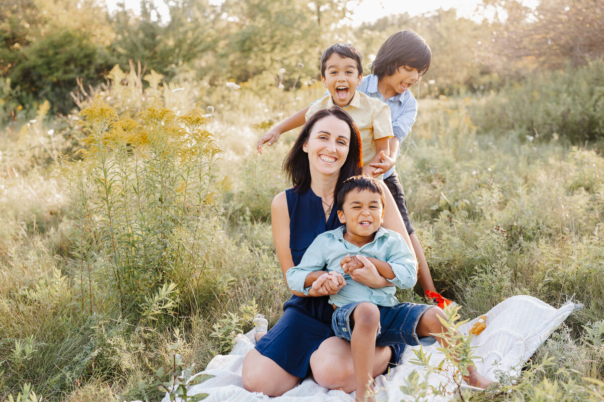 Boys show lots of love to their Mama during their family photoshoot.