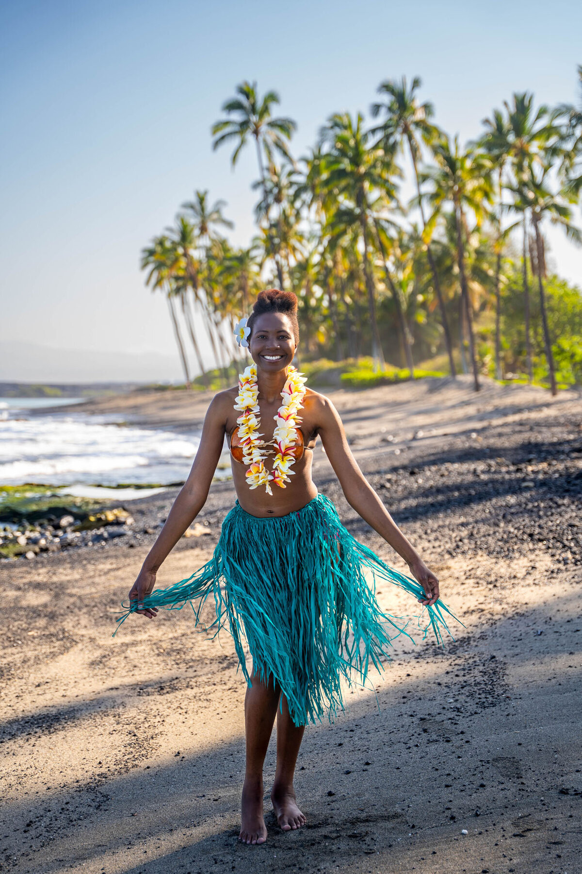 hawaii portrait photography of woman in hula skirt and lei on the beach