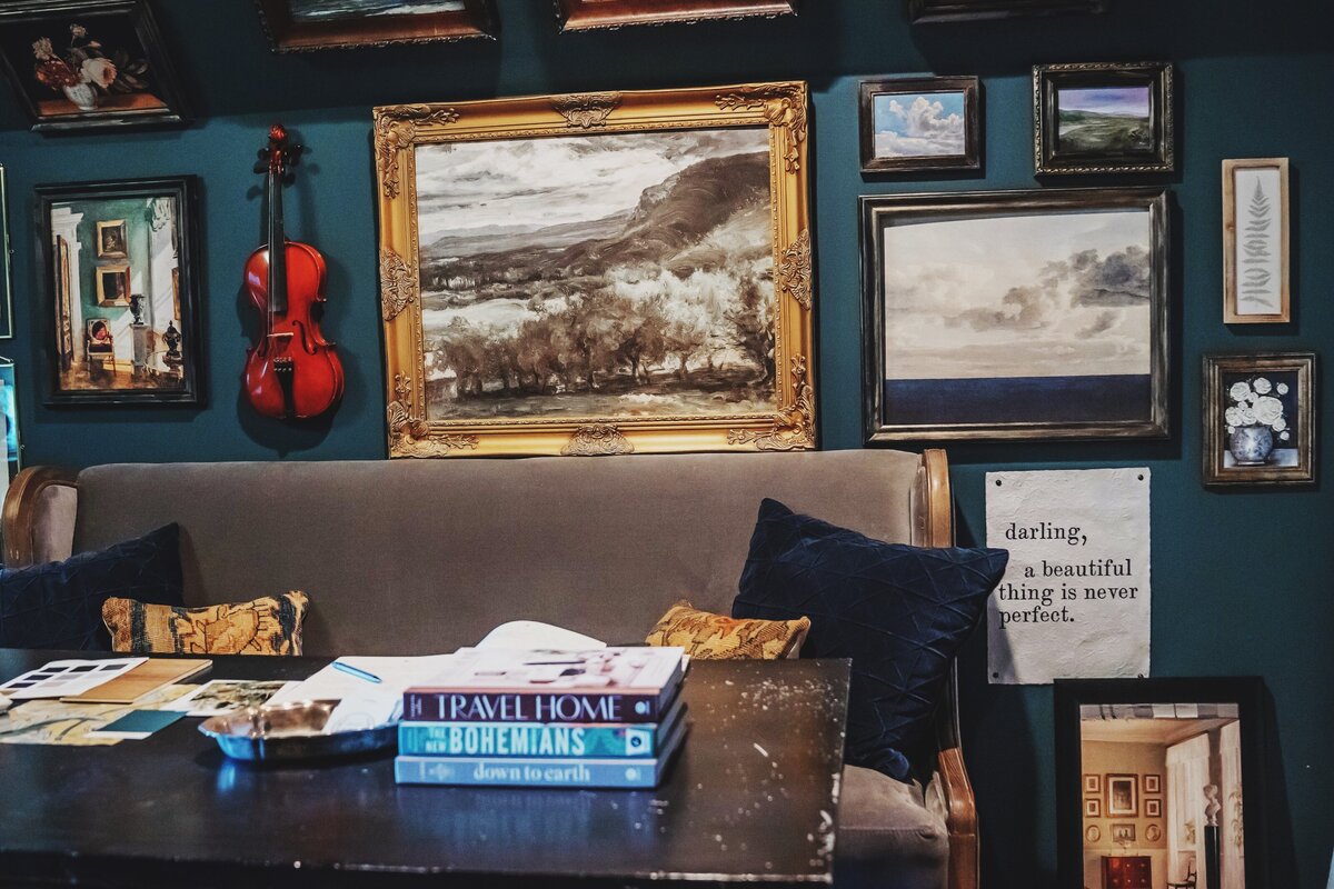Gallery wall and sofa bench with interior design selections on table