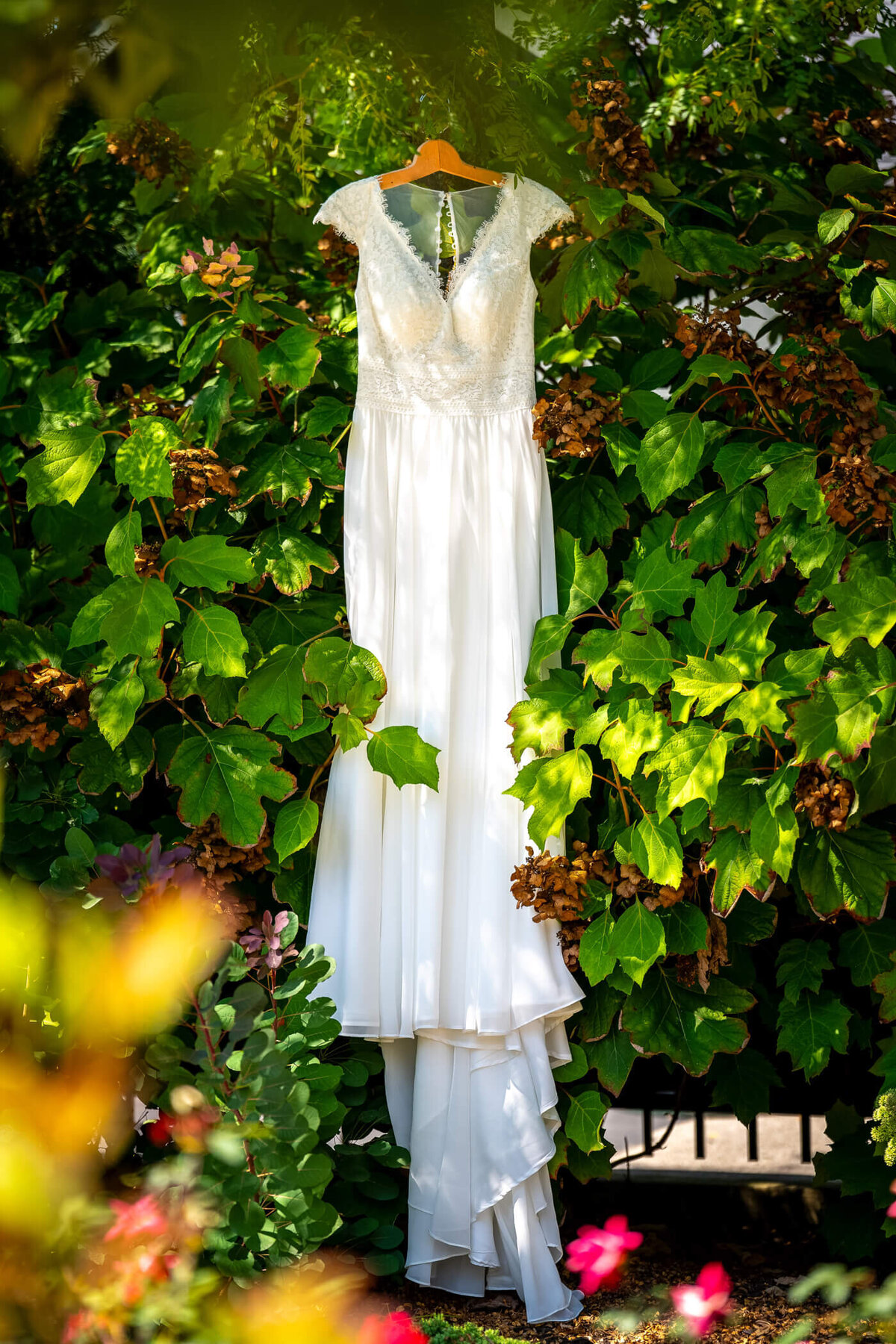Pittsburgh detailed wedding photography of a natural detail shot of bride's dress hung in the garden of beaver train station wedding venue in beaver PA