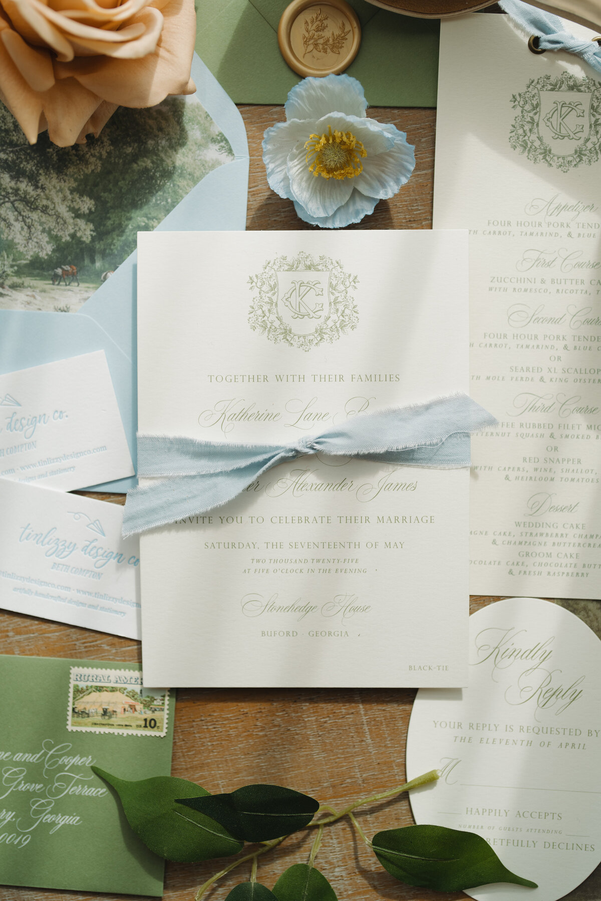 Wedding invitation with soft blue ribbon.
