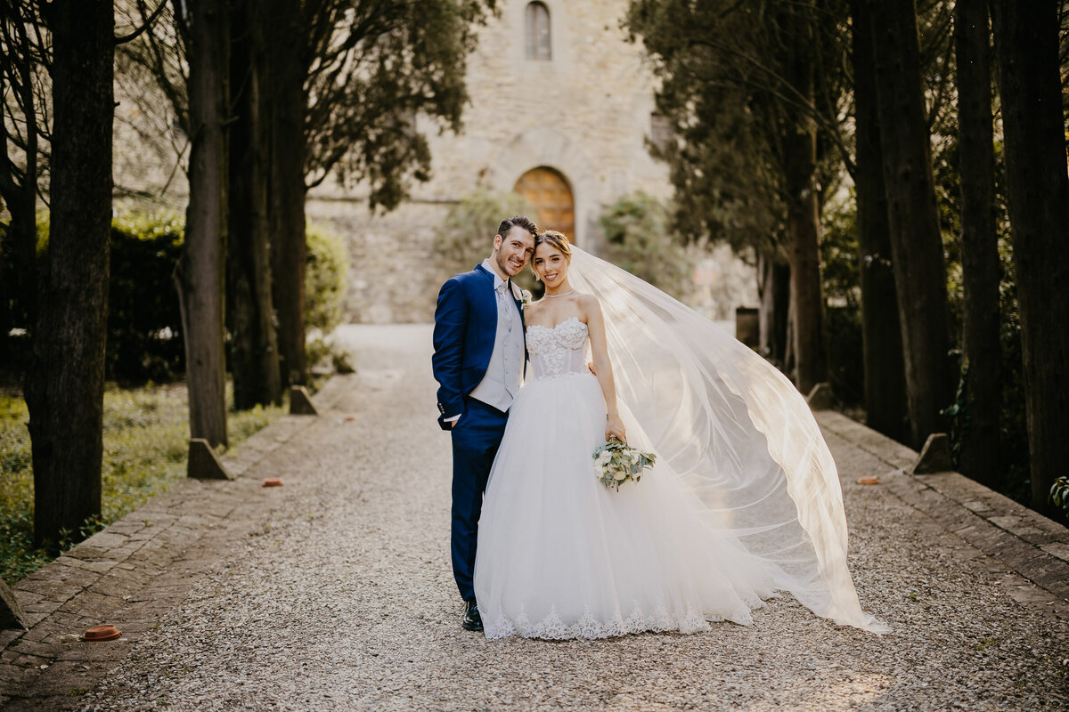 Bride and groom posing in front of Castello il Palagio Chianti, wedding photographer Tuscany.