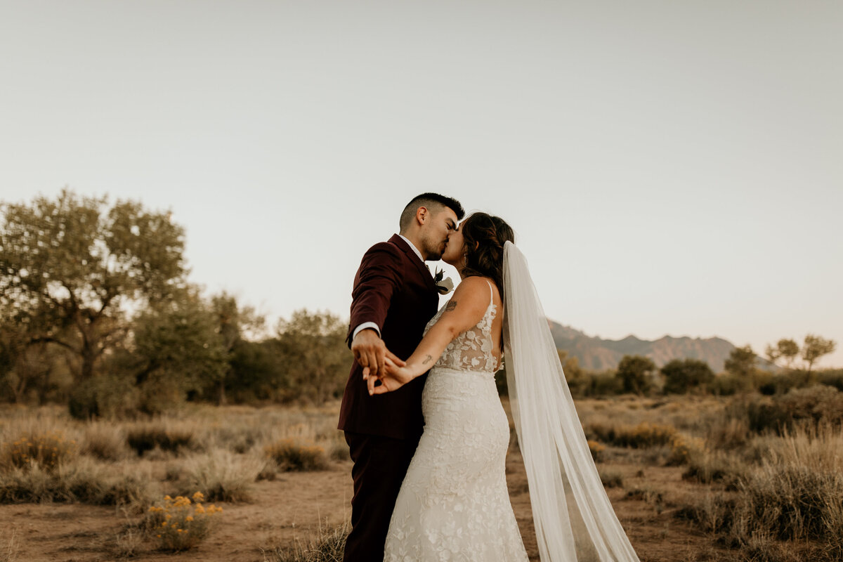 bride and groom dancing together in the desert in Albuquerque