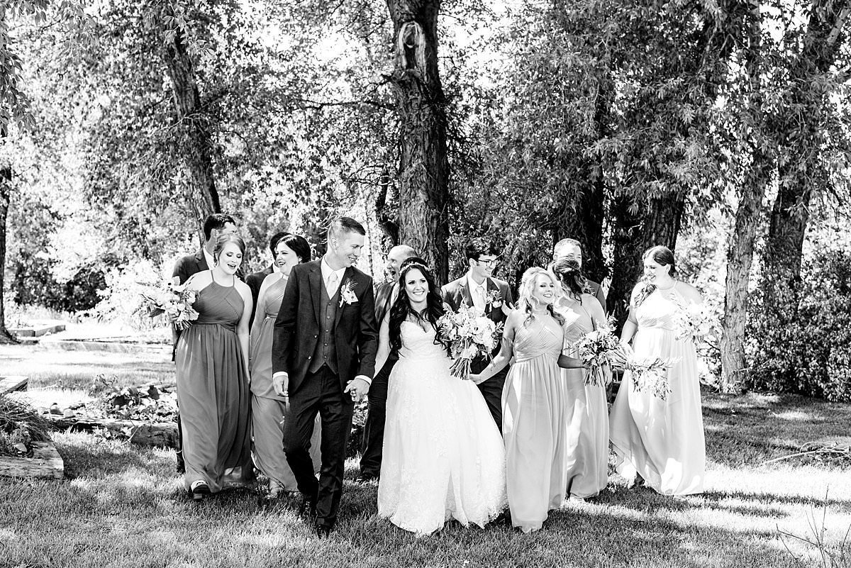 Black and White photo of wedding party strolling through Montana countryside