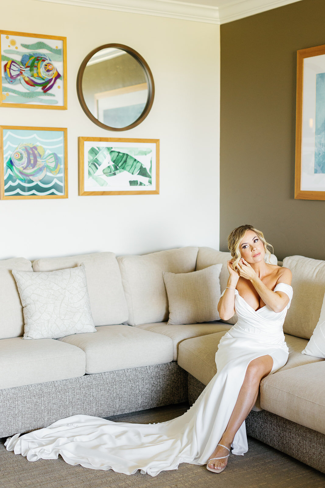Monica in a fitted wedding gown, elegantly seated on a sofa, soaking in the special moments of her micro wedding in Islamorada.