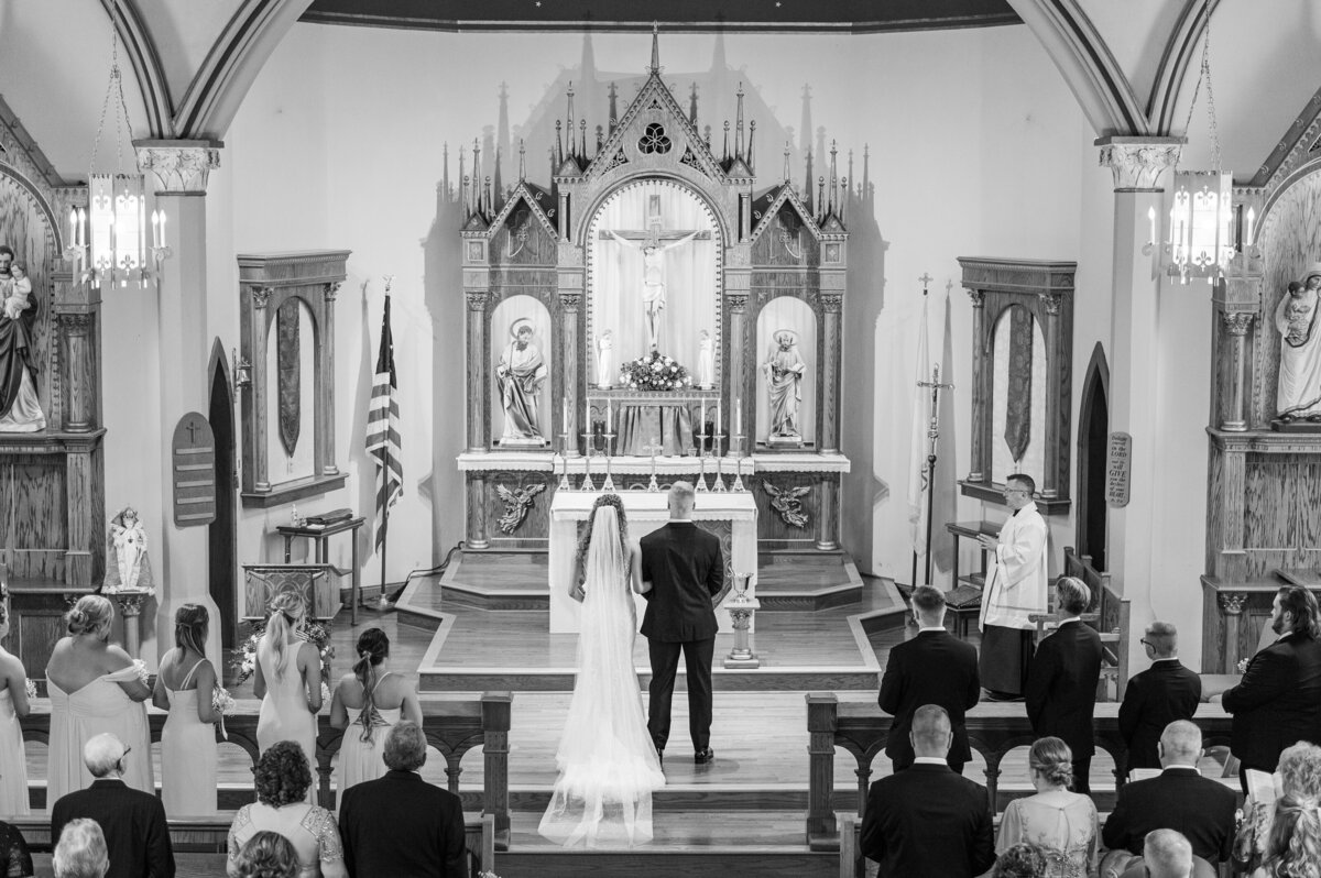 bride and groom at their catholic church altar getting married