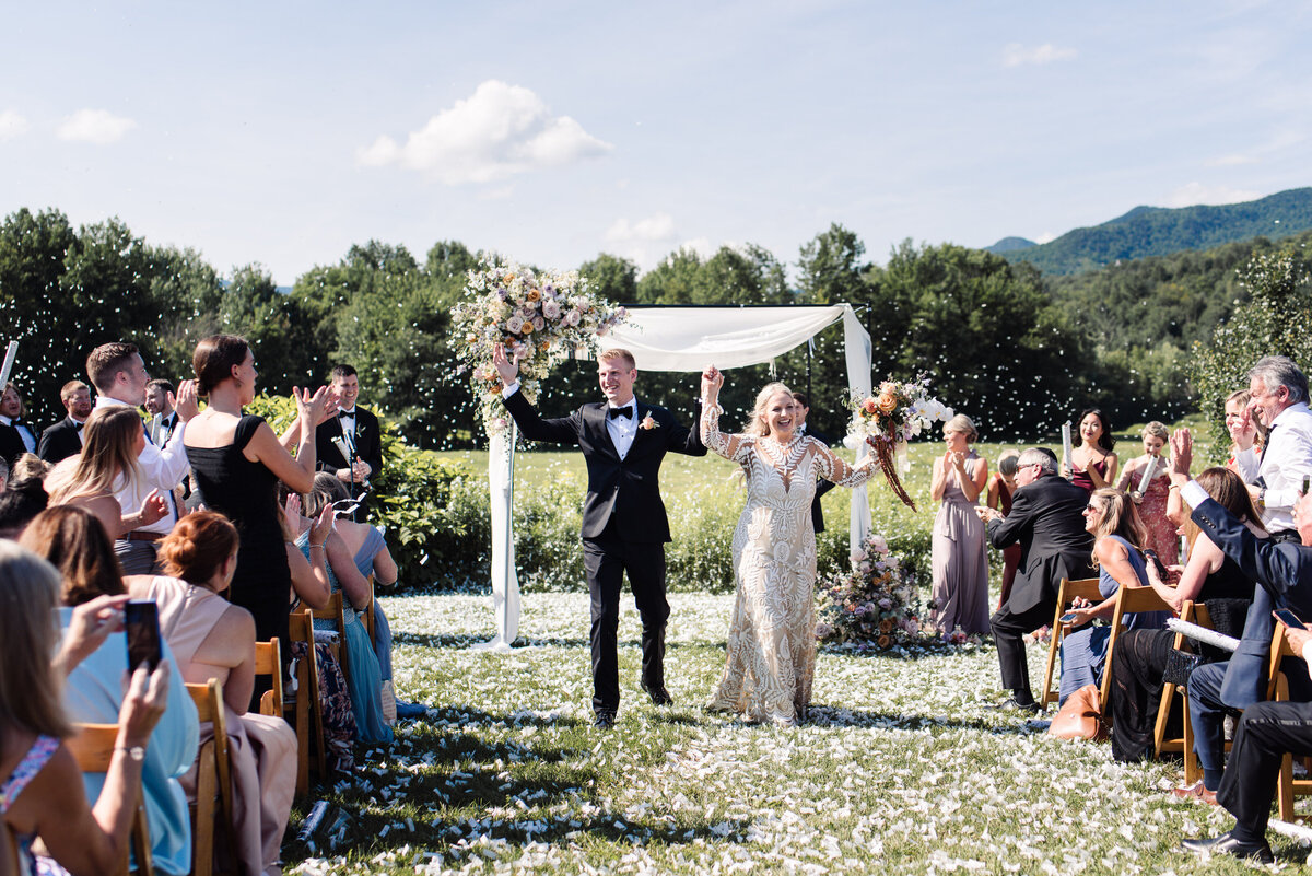 Just married couple walks down confetti aisle at Topnotch Resort and Spa in Stowe, VT