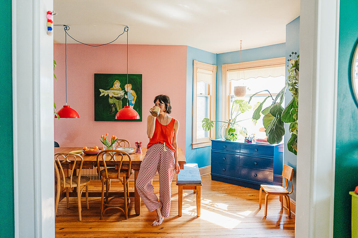 designer stands in colorful kitchen