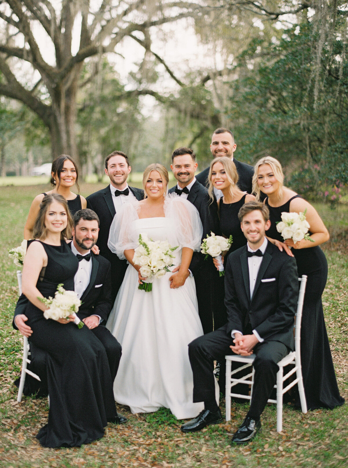 Bride and groom take portraits with their wedding party