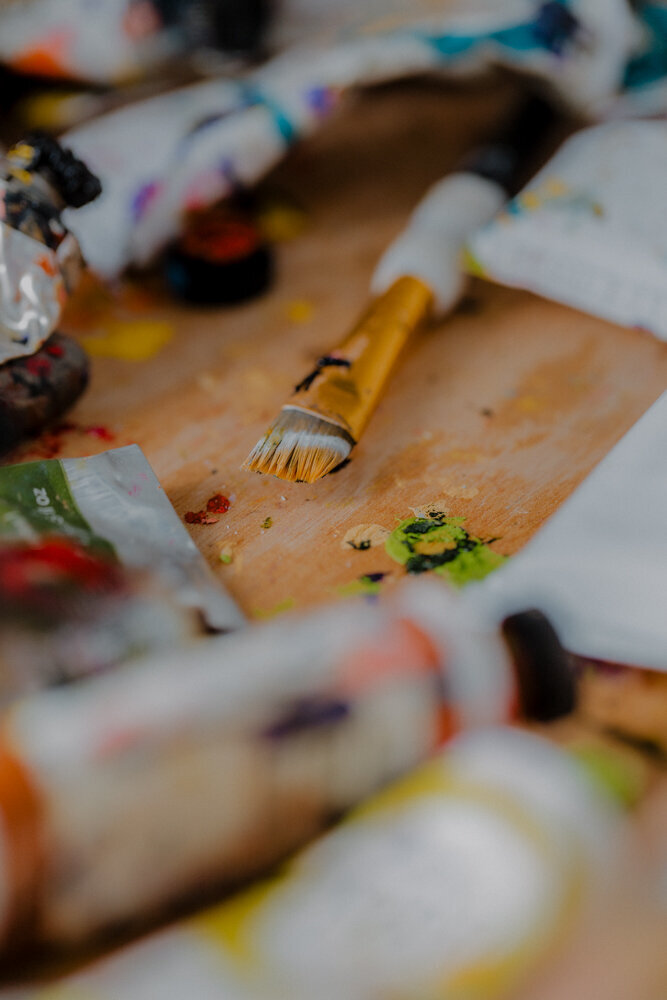 paint brush dipped in yellow paint