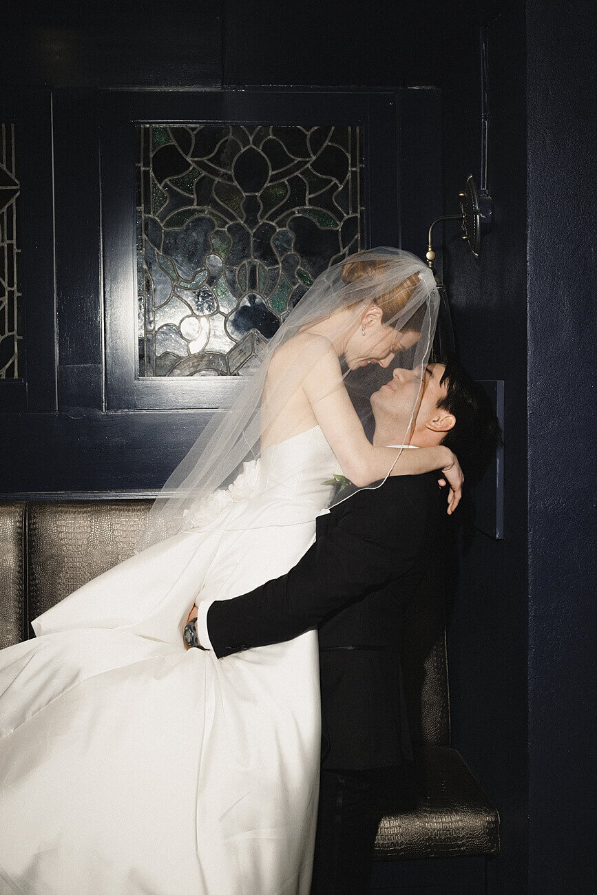 groom picking up bride for a kiss