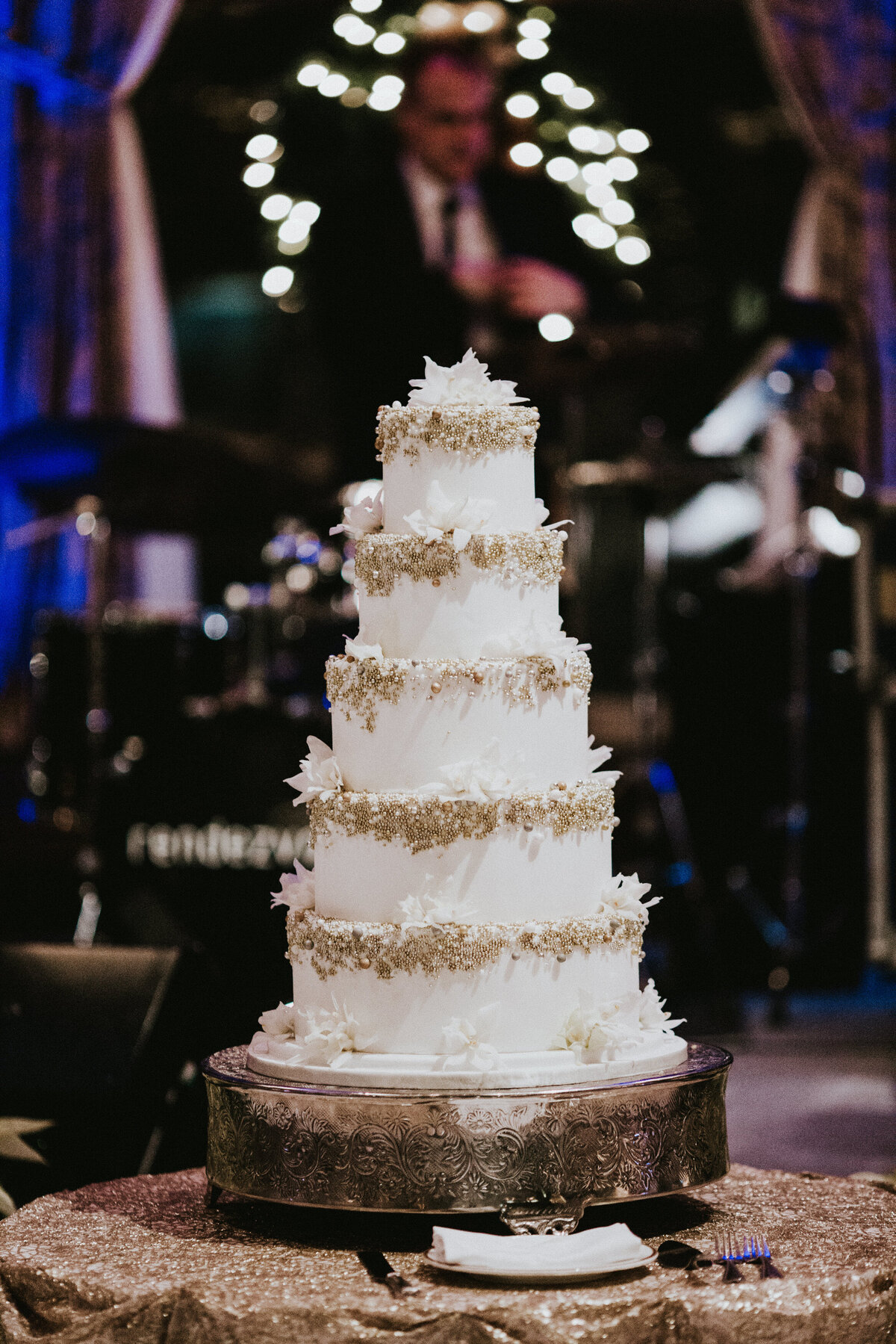 Five tier wedding cake with gold detailing