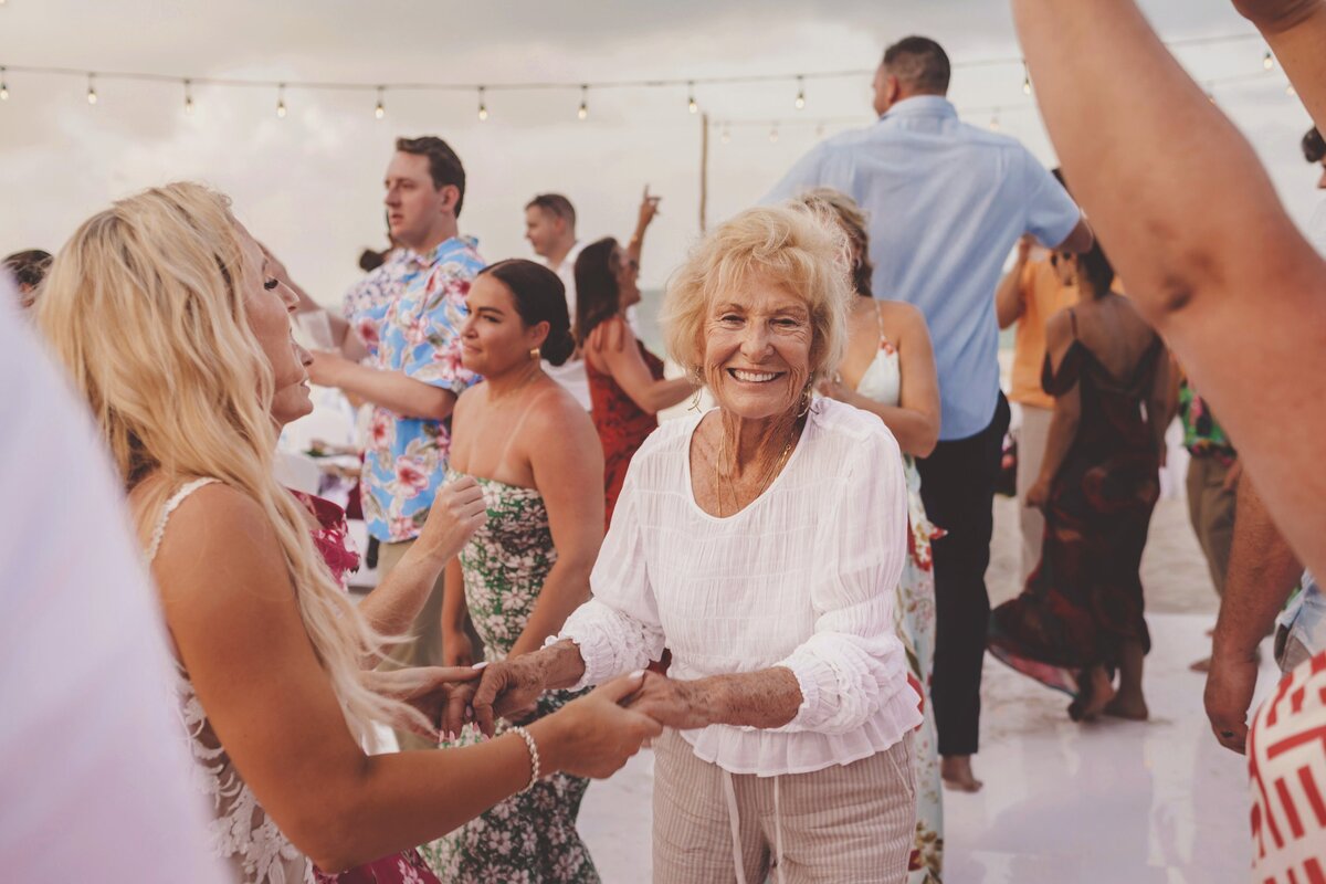 Grandma dancing with bride at wedding in Cancun