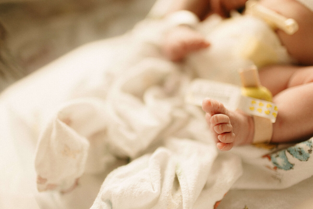 Parents holding newborn together in hospital bed during Nashville Fresh 48.