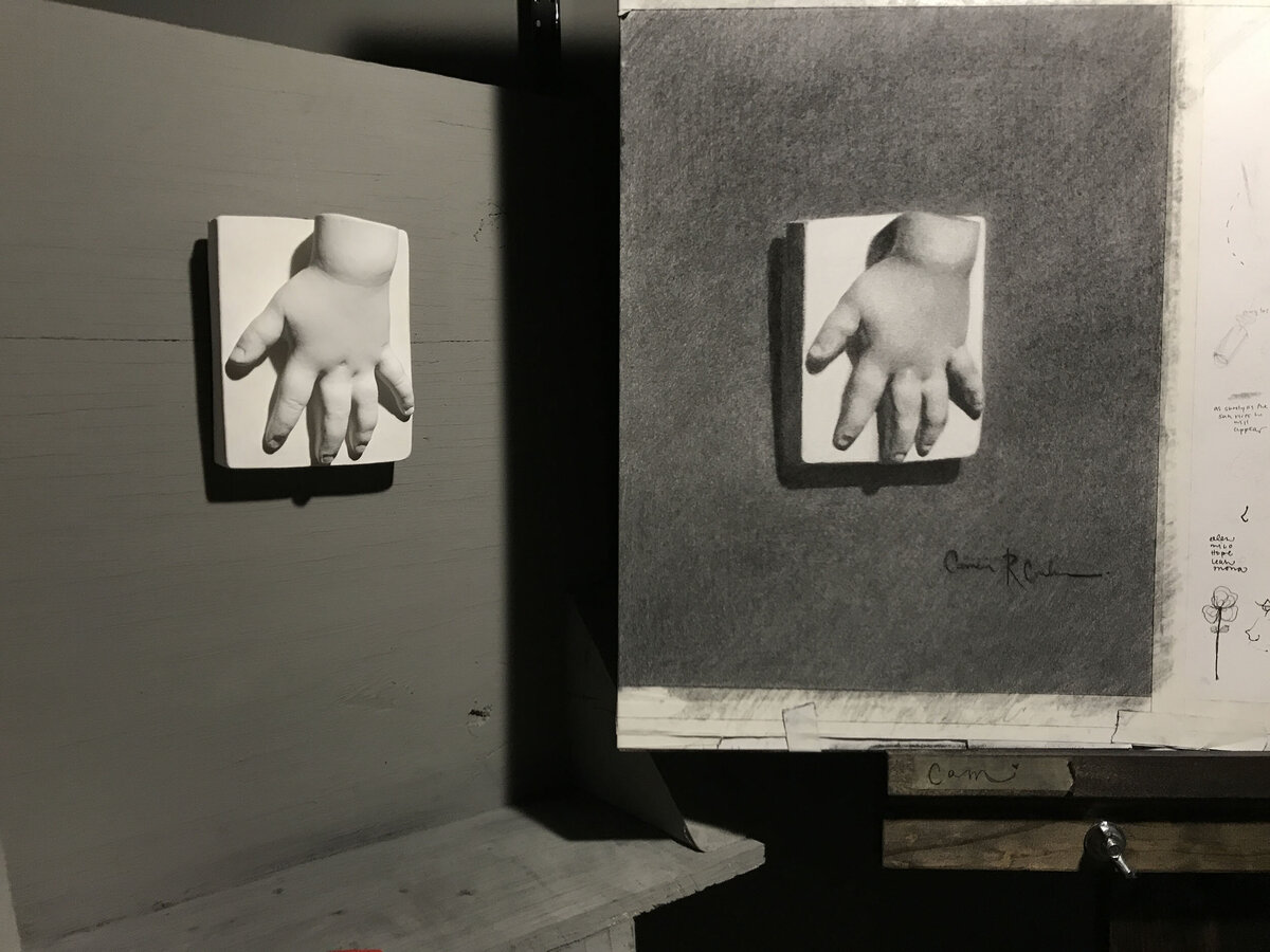 Artist Cam Rose's black and white charcoal sketch of cast baby hand