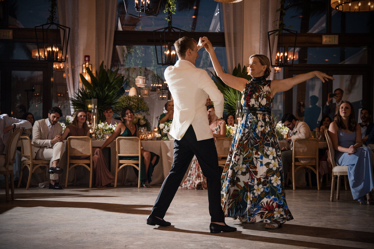 A groom dances with his mother  at a destination wedding in Puerto Rico