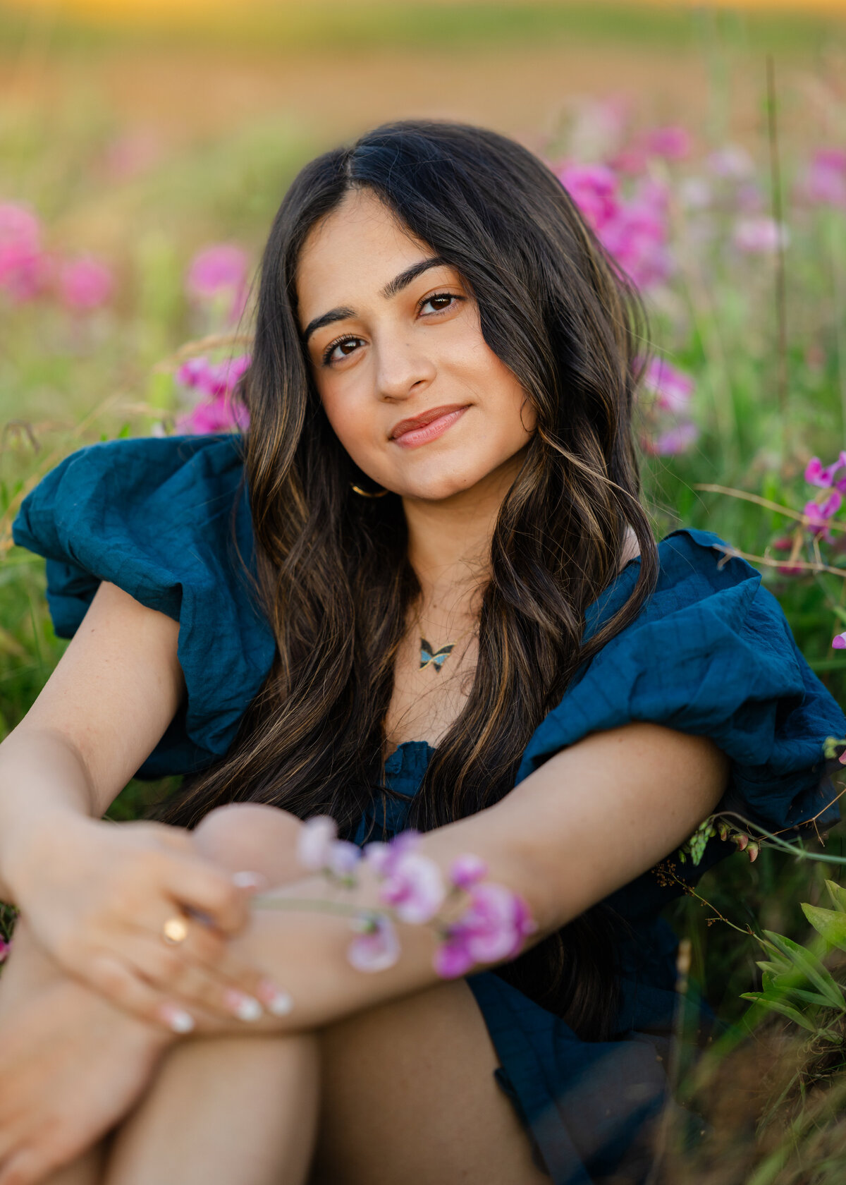issaquah senior girl sitting in sweet pea wildflower field