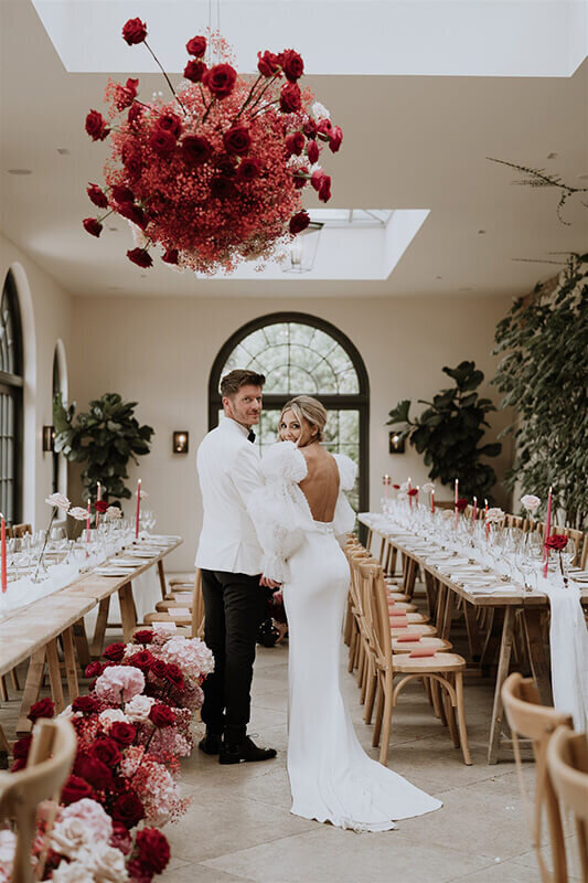 Bride and groom stood under wedding cloud