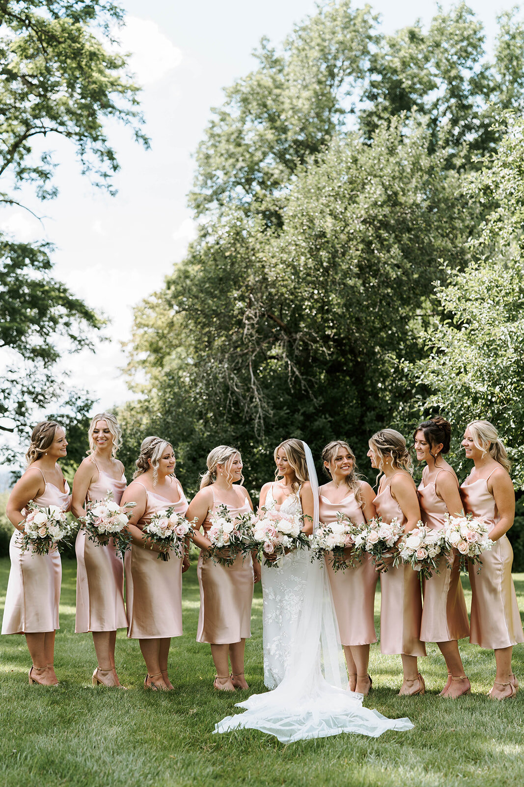 bridesmaids in blush satin dresses and bride girls outdoor formal portrait